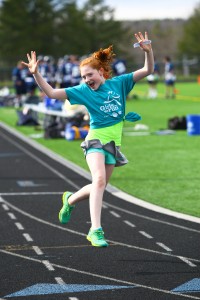 A girl celebrates while running her 5k at the end of her partcipation in the program, location and date unspecified | Photo courtesy of Girls on the Run, St. George  News