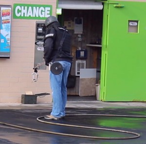 A Washington County Bomb Squad technician removes a suspicious device from the office of the Ultra Car Wash, St. George, Utah, Jan. 2, 2016 | Photo by Ric Wayman, St. George News