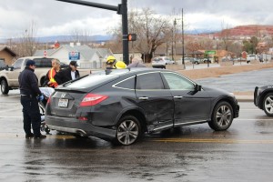 A woman is removed from her damaged car after being hit by a driver that ran a red light, Washington, Utah, Jan. 6, 2016 | Photo by Ric Wayman, St. George News