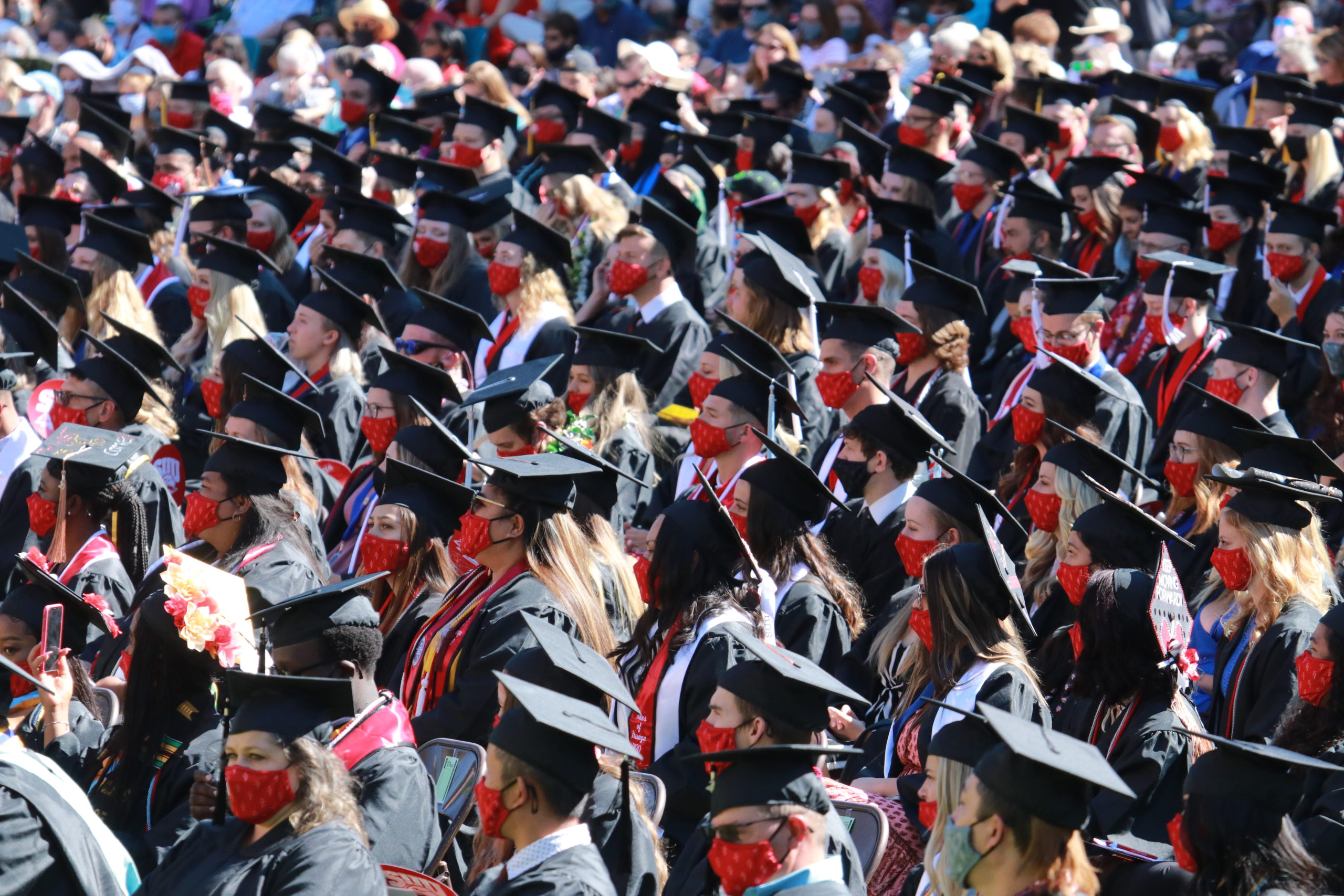 Maskwearing graduates participate in SUU commencement, one of the few