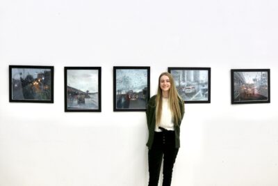 Melissa Ferguson stands in front of her oil painting series, March 22, 2022, St. George, Utah | Photo by Jessi Bang, St. George News