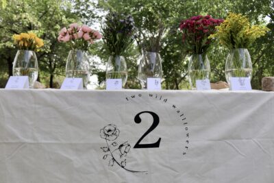 A table with flowers and their individual meanings set up at a local park for an upcoming flower workshop, April 11, 2022, St. George, Utah | Photo by Jessi Bang, St. George News