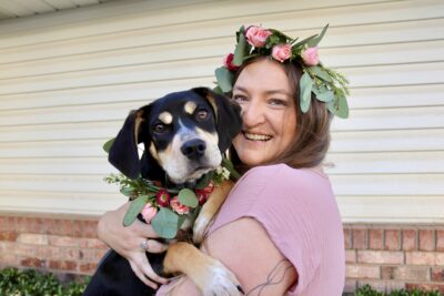 Cammie Hust, owner and founder of Two Wild Flowers, poses with her dog, both wearing custom flower crowns, April 11, 2022, St. George, Utah | Photo by Jessi Bang, St. George News