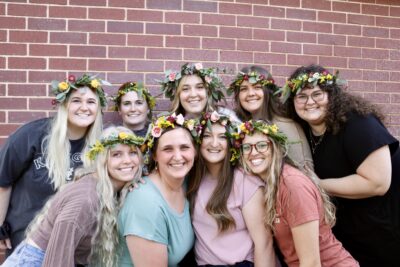 Attendees of Two Wild Flowers' crown workshop pose together wearing their hand-made crowns, April 11, 2022, St. George, Utah | Photo by Jessi Bang, St. George News