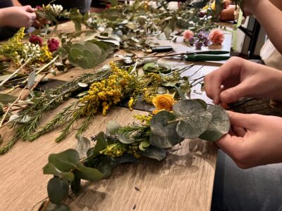 Attendees of Two Wild Flowers' crown workshop work on their flower crowns, April 11, 2022, St. George, Utah | Photo by Jessi Bang, St. George News