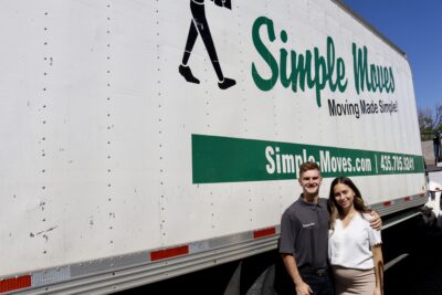 Simple Moves' owners Kade and Breanna Cummings stand in front of their moving truck, St. George, Utah, May 15, 2022 | Photo by Jessi Bang, St. George News