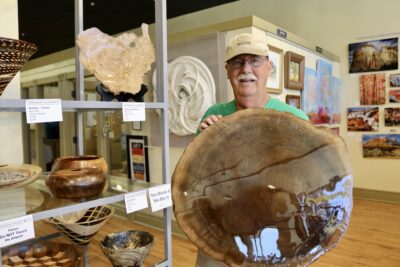 Barry gray, a woodturner and 3D wood artist, holds a piece of wood art he created, St. George, Utah, May 18, 2022 | Photo by Jessi Bang, St. George News