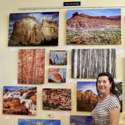 Ilene Bandriga, Arrowhead Gallery Chairperson, stands in front of her photography, St. George, Utah, May 18, 2022 | Photo by Jessi Bang, St. George News