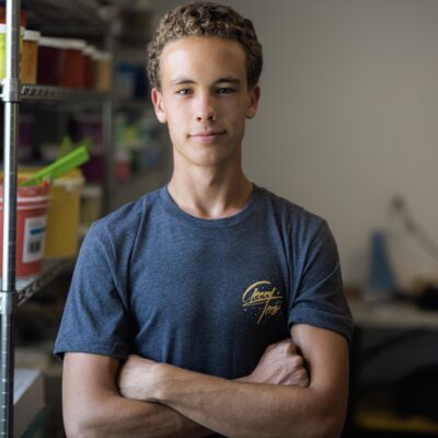 Employee Dusty Hart stands inside Geezy Tees, St. George, Utah, date unspecified | Photo courtesy of Kyler Kelsch, St. George News