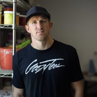 Kyler Kelsch, owner of Geezy Tees, stands in his shop, location and date unspecified | Photo courtesy of Kyler Kelsch, St. George News