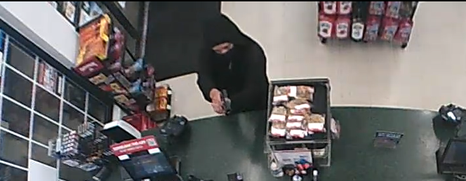 CCTV Footage Shows Customer Stealing Gunman's Loot During Armed Robbery