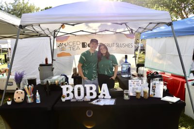 Trent and Alexis Anderson pose together in their Boba Go booth at the St. George Downtown Farmers Market, September 3, 2022 | Photo by Jessi Bang, St. George News