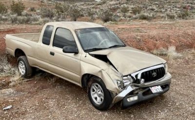 A vehicle involved in a roll-over crash on I-15 Tuesday morning sits on the side of the roadway in Hurricane, Utah on Feb. 28, 2023 | Photo courtesy of Patrol Sgt. Joe Pastor, St. George News