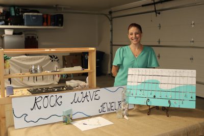 Jona Davis smiles for the camera with her custom jewelry line created from Hawaiian sea glass, sea shells and Utah rocks, St. George, Utah, Feb. 27, 2023 | Photo by Jessi Bang, St. George News