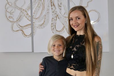 Christine Lawson, the owner of Hippie Whipped, stands inside her home in Ivins, Utah with her son on March 6, 2023 | Photo by Jessi Bang, St. George News