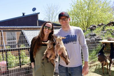 Rachel Postma and husband Schyler hold two baby goats on their farm in Hurricane, Utah, April 14, 2023 | Photo by Jessi Bang, St. George News