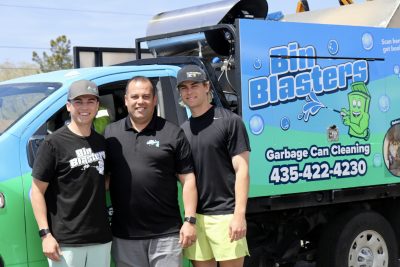 (Left to right) Kaden Terry, Steve Terry and Kyler Terry, family owners of Bin Blasters take a photo next to their company truck in St. George, Utah, April 17, 2023 | Photo by Jessi Bang, St. George News