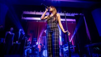 Sarah Birch performs on stage in front of a live audience, location and date unspecified | Photo courtesy of Sarah Birch, St. George News