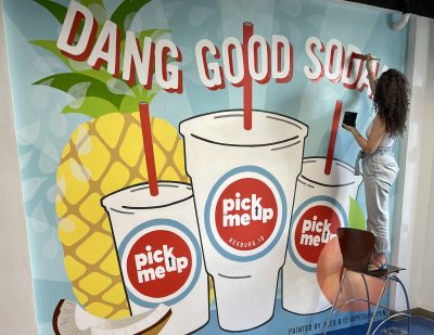 Alex Peterson works on a mural at Pick Me up in Rexburg, Idaho, June 2021 | Photo courtesy of Alex Peterson, St. George News