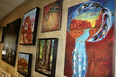 A variety of digital and painted art by Desert Art Vibe hangs on the wall in St. George, Utah, July 19, 2023 | Photo by Jessi Bang, St. George News