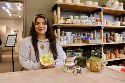 Kelsey Wheeler shows off some of her latest work inside The Tilted Kiln in St. George, Utah, Aug. 15, 2023 | Photo by Jessi Bang, St. George News