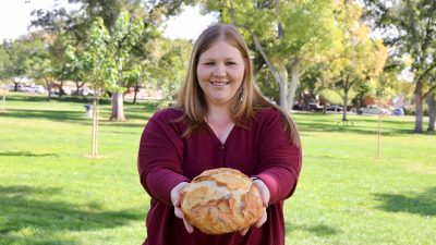 Nessie’s Sweet n Savory owner Janessa Wight stands with a loaf of her sourdough bread in St. George, Utah, Oct. 2, 2023 | Photo by Jessi Bang, St. George News