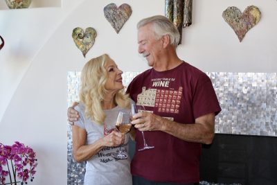 Marianne and Doug Hamilton, the founders of the Southern Utah Wine Guild clink wine glasses together inside their home in St. George, Utah, Sept. 26, 2023 | Photo by Jessi Bang, St. George News