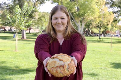 Nessie’s Sweet n Savory owner Janessa Wight stands with a loaf of her sourdough bread in St. George, Utah, Oct. 2, 2023 | Photo by Jessi Bang, St. George News