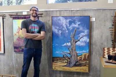 Matt Pectol stands next to one of his paintings inside Juniper Sky Gallery at the Kayenta Art Village in Ivins, Utah, Oct. 25, 2023 | Photo by Jessi Bang, St. George News