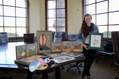 Artist Rachel Mangan stands with her various art mediums in St. George, Utah, Dec. 13, 2023 | Photo by Jessi Bang, St. George News