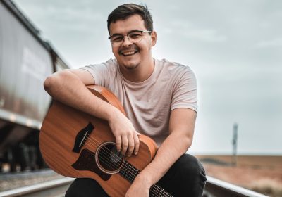Artist Noah Deist, whose social media fame rose from music looping, takes a photo with his guitar, location and date unspecified | Photo courtesy of Noah Diest, St. George News
