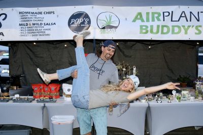 Harry and Summer Altena, founders of the Wednesday Night Market, pose together for a photo in front of their booth, St. George, Utah, March 6, 2024 | Photo by Jessi Bang, St. George News