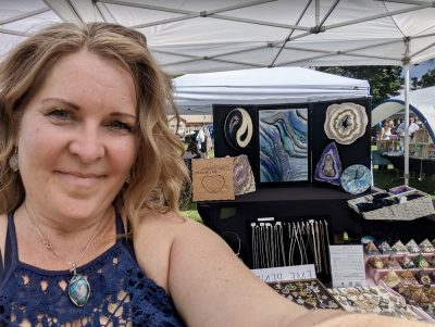 Monica Iglesias takes a photo in front of her booth at a local event, location and date not specified | Photo courtesy of Monica Iglesias, St. George News