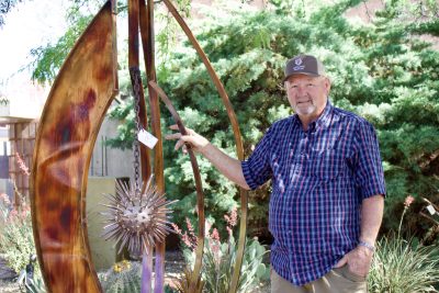 Lance Ludlow stands next to one of his metal sculptures on display outside Gallery 873, Ivins, Utah, May 22, 2024 | Photo by Jessi Bang, St. George News