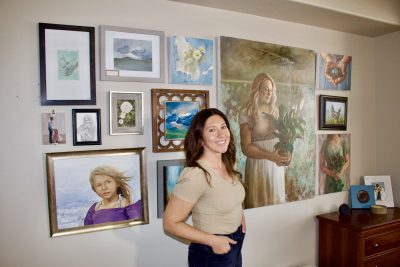 Megan Schaugaard stands next to her artwork inside her art studio in Washington City, Utah, May 23, 2024 | Photo by Jessi Bang, St. George News