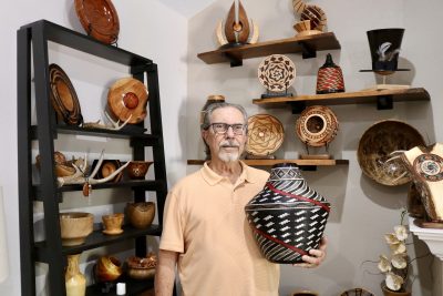 Woodturning artisan Ken Ragsdale stands next to his work in Cedar City, Utah, July 10, 2024 | Photo by Jessi Bang, St. George News